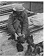 1940 soldier changes into dry clothing in Dover